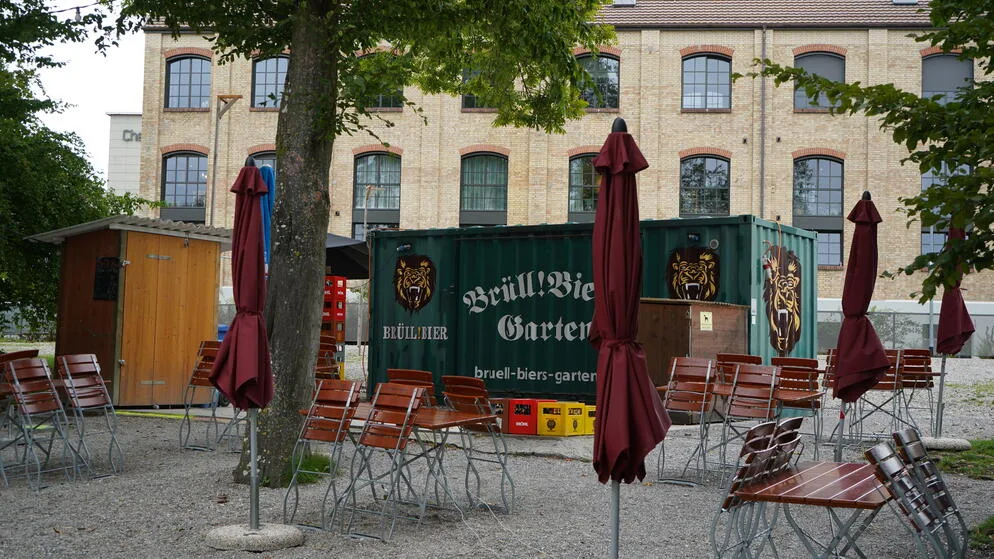 Blick auf hochgeklappte Stühle und ein Container.